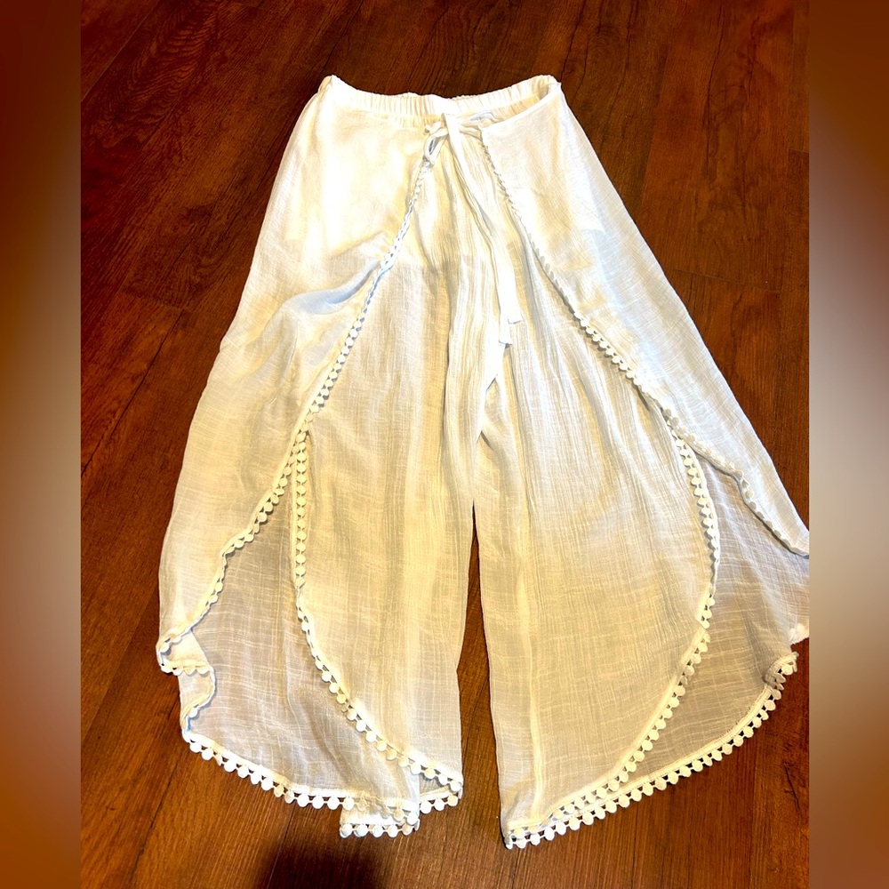 Women’s white shorts with pants overlay.